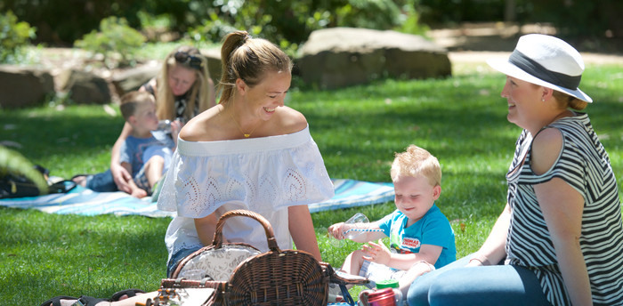 Women and toddlers enjoying a picnic at Healesville Sanctuary.