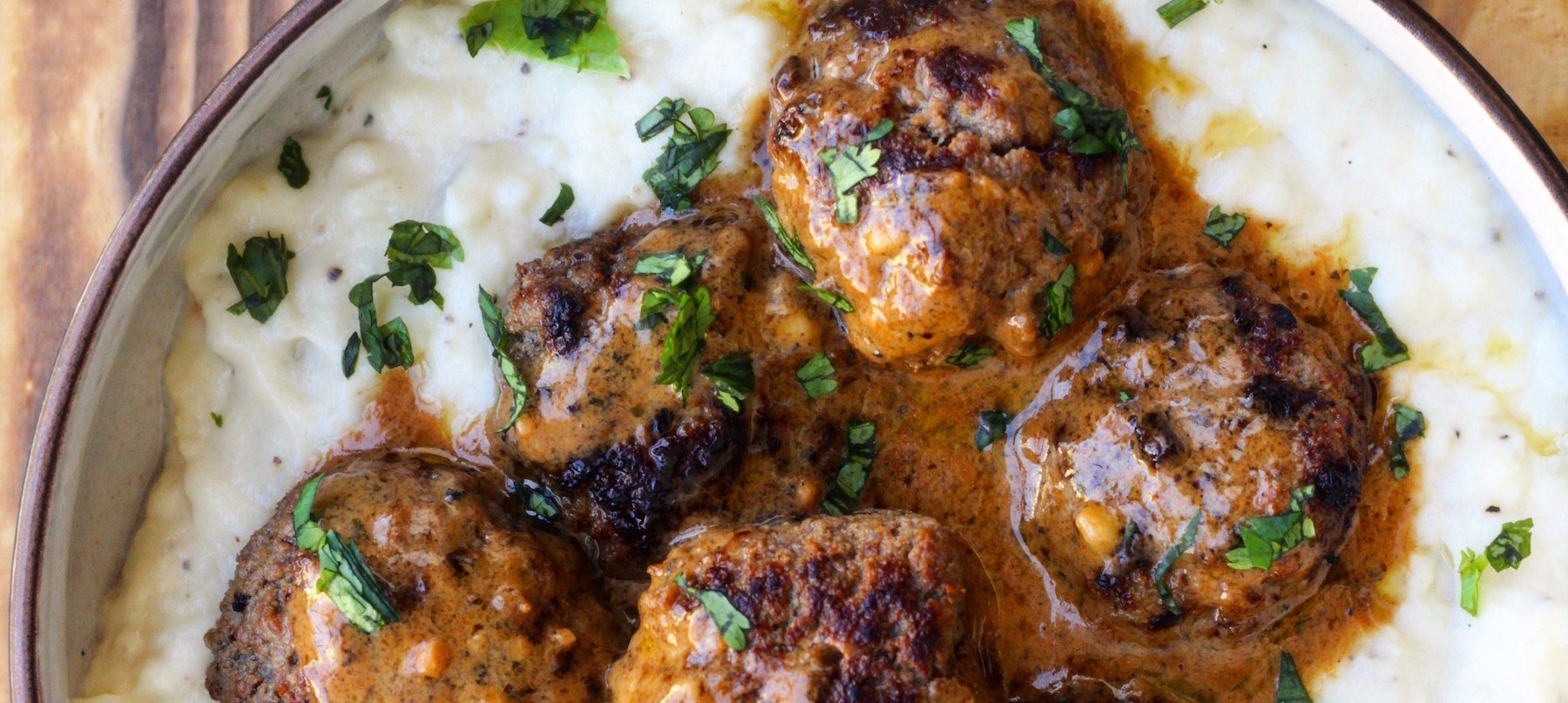 Cauliflower mash with meatballs smothered in gravy